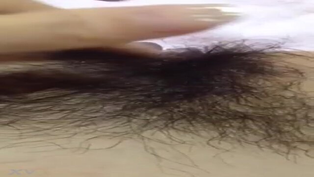 Drenched Japanese girl plays with her juicy cunt